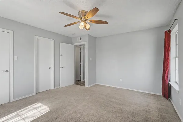a view of a livingroom with a chandelier fan