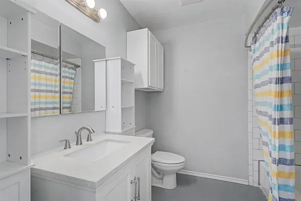 a bathroom with a sink toilet and shower