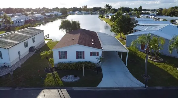 an aerial view of a house with outdoor space and lake view