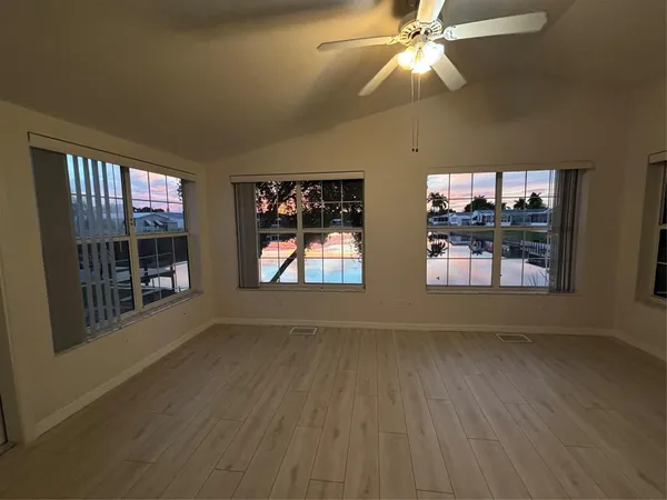 wooden floor in an empty room with a window