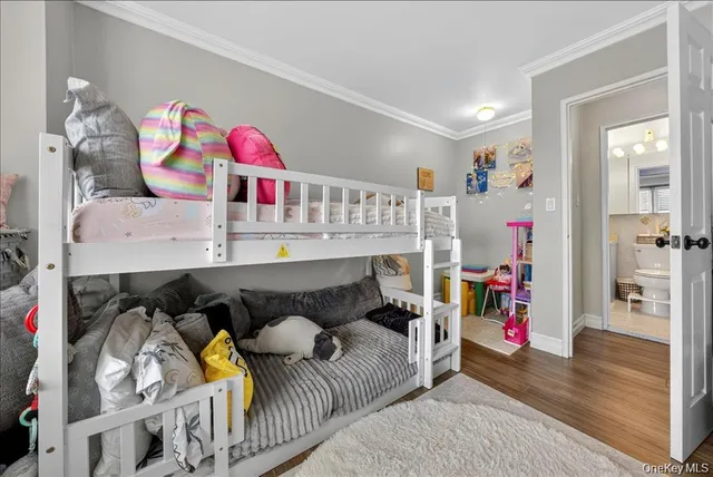 a bedroom with furniture and a wooden floor