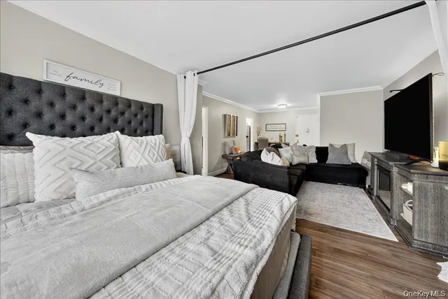 a living room with furniture a flat screen tv and a table