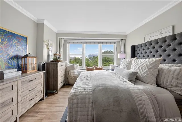 a bed sitting in a bedroom next to a window with a dresser