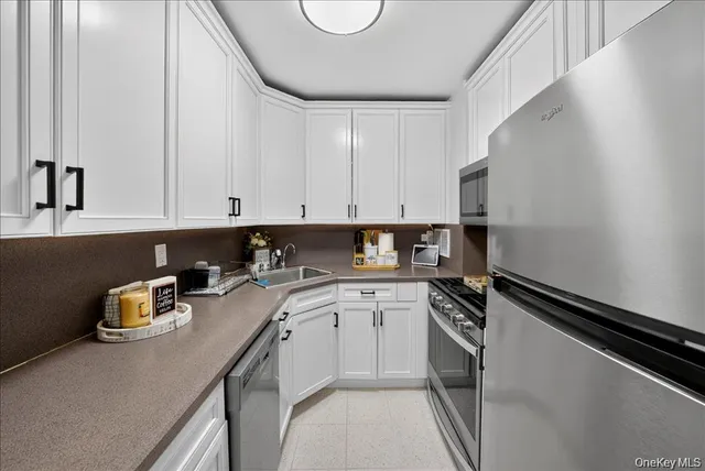 a kitchen with a sink cabinets and appliances