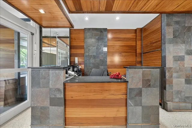 a bathroom with a granite countertop sink and a shower