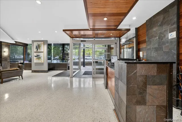 a lobby with furniture and large windows