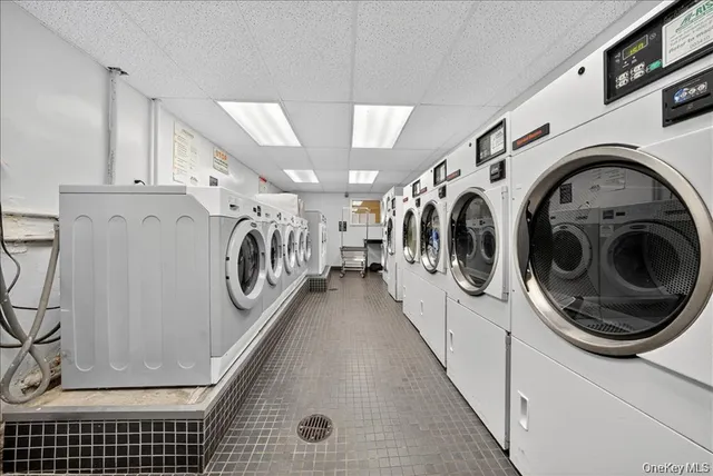 a view of washer and dryer with kitchen in the background