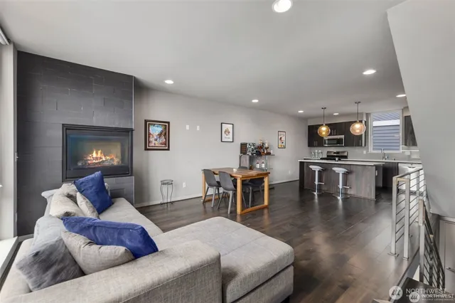 a living room with furniture and kitchen view