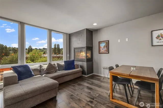a living room with furniture and large windows
