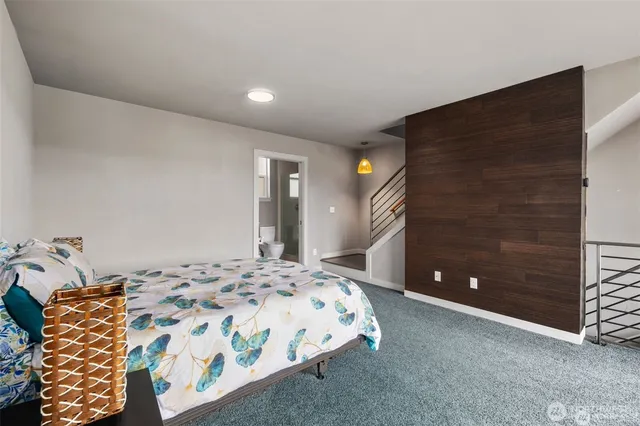 a bedroom with a bed and a potted plant