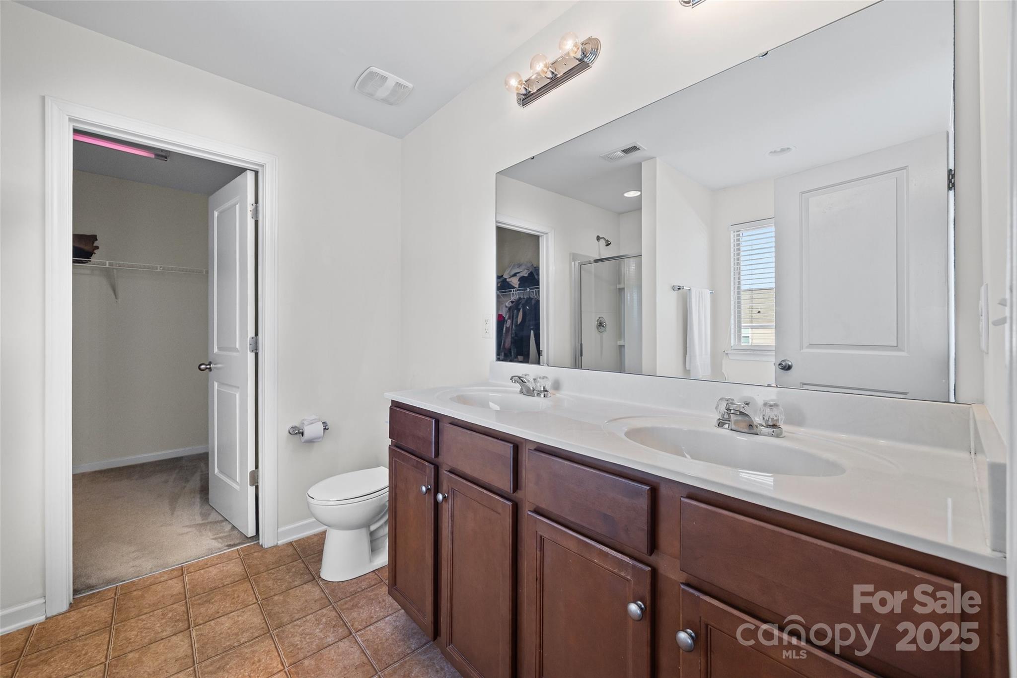 2811 Berry Creek Road Charlotte, NC 28214 - Photo 16 of 20 a spacious bathroom with a granite countertop sink toilet and shower