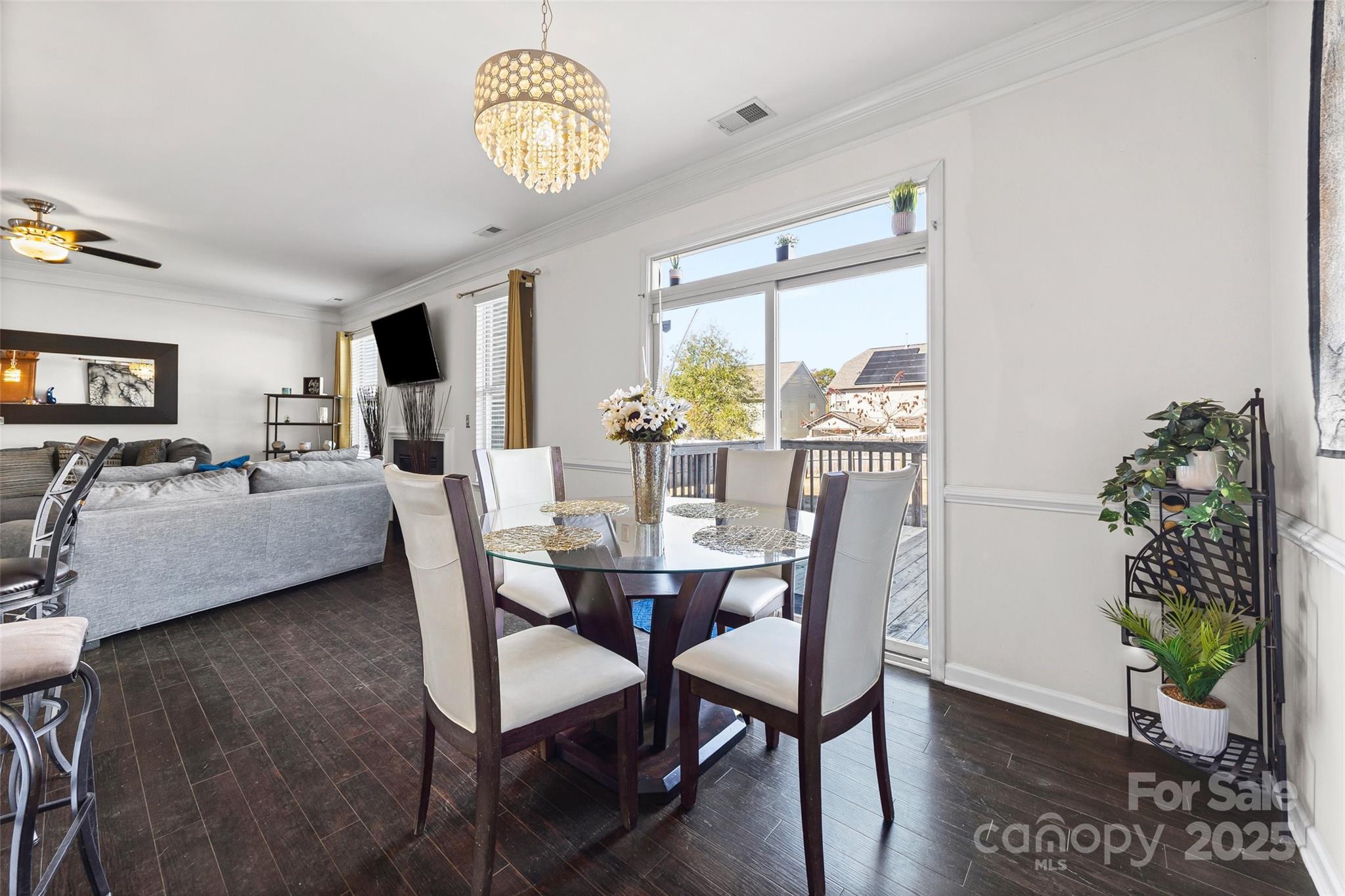 2811 Berry Creek Road Charlotte, NC 28214 - Photo 5 of 20 a view of a dining room with furniture a livingroom and chandelier