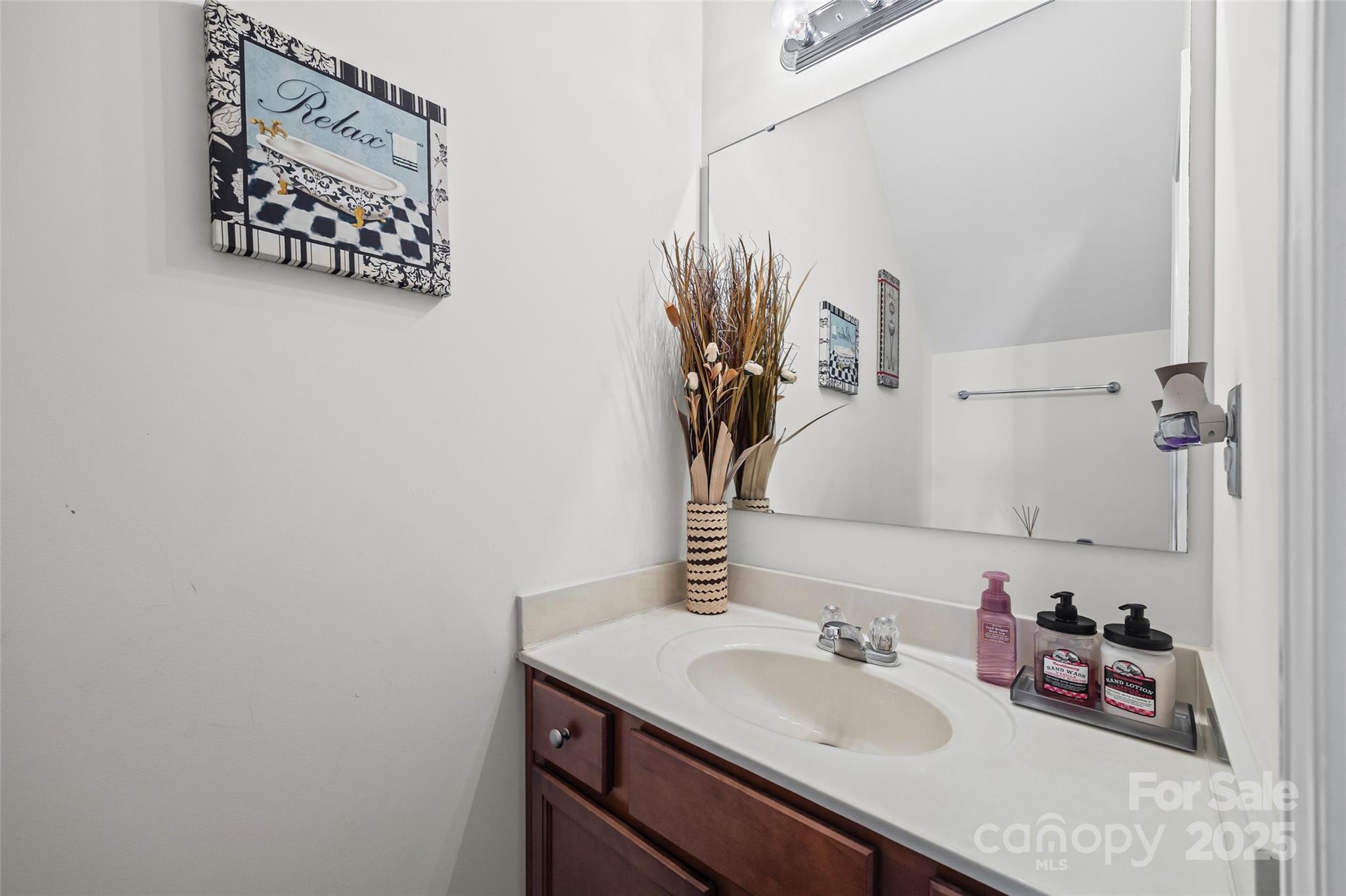 2811 Berry Creek Road Charlotte, NC 28214 - Photo 9 of 20 a bathroom with a sink and a mirror