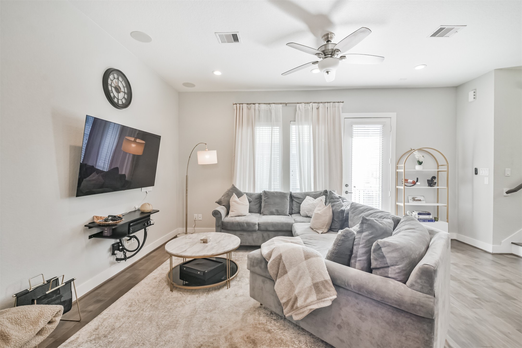8411 Hempstead Road, Unit H Houston, TX 77008 - Photo 11 of 40 A stylish ceiling fan adds both function and elegance, while the beautiful floors complete the space, offering warmth and sophistication.