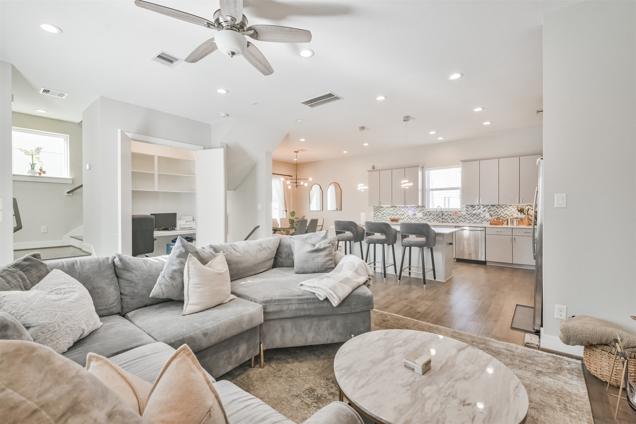 8411 Hempstead Road, Unit H Houston, TX 77008 - Photo 13 of 40 custom office seamlessly integrates into the living room, offering a stylish and functional workspace without sacrificing comfort or flow.