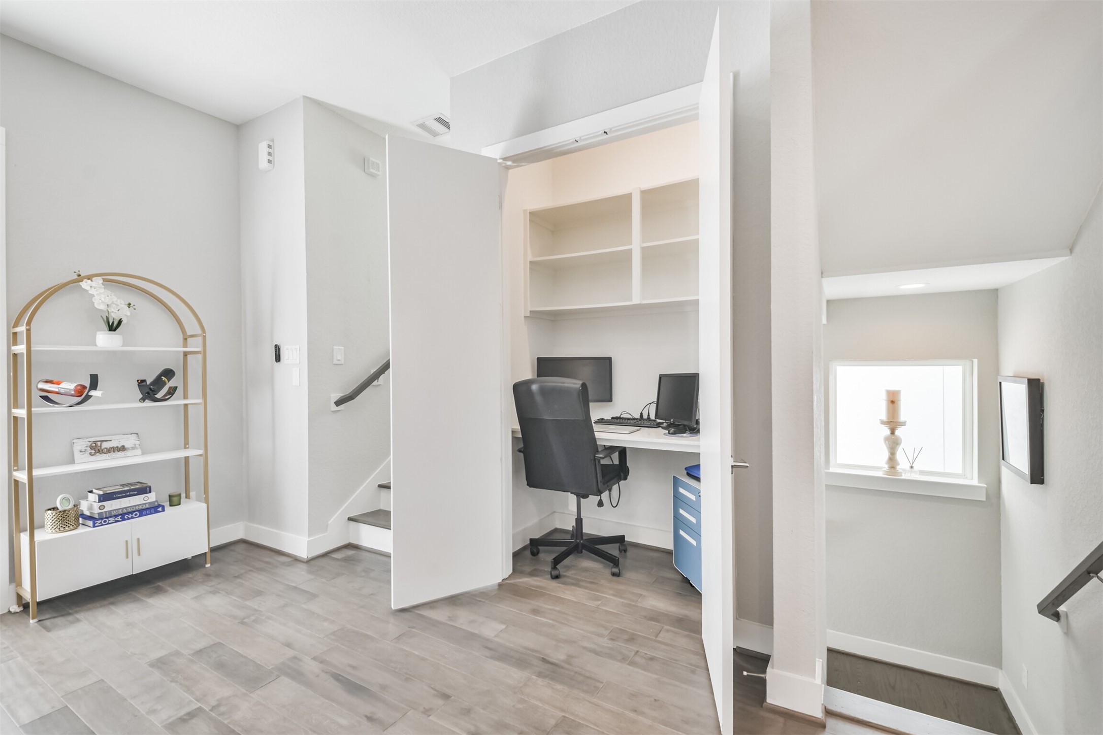 8411 Hempstead Road, Unit H Houston, TX 77008 - Photo 15 of 40 This thoughtfully designed custom office seamlessly integrates into the living room, offering a stylish and functional workspace without sacrificing comfort or flow.