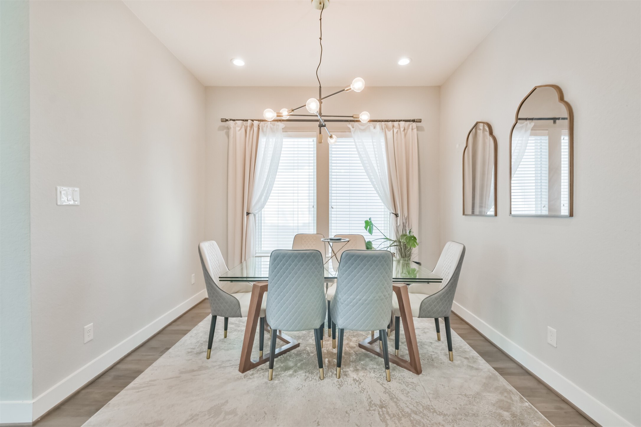8411 Hempstead Road, Unit H Houston, TX 77008 - Photo 22 of 40 The room is framed by tall, draped windows allowing natural light to filter in, complementing the sophisticated ambiance.