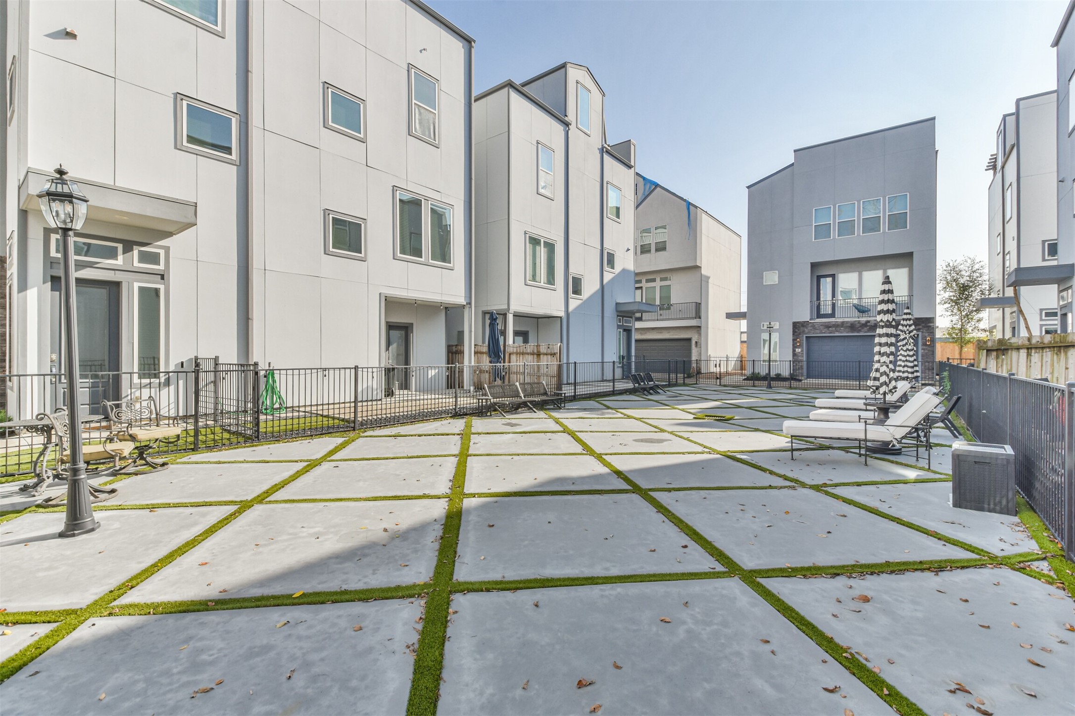 8411 Hempstead Road, Unit H Houston, TX 77008 - Photo 39 of 40 A peaceful sunbathing area with comfortable lounge chairs perfect for homeowners to enjoy a morning stroll or walk their dogs.