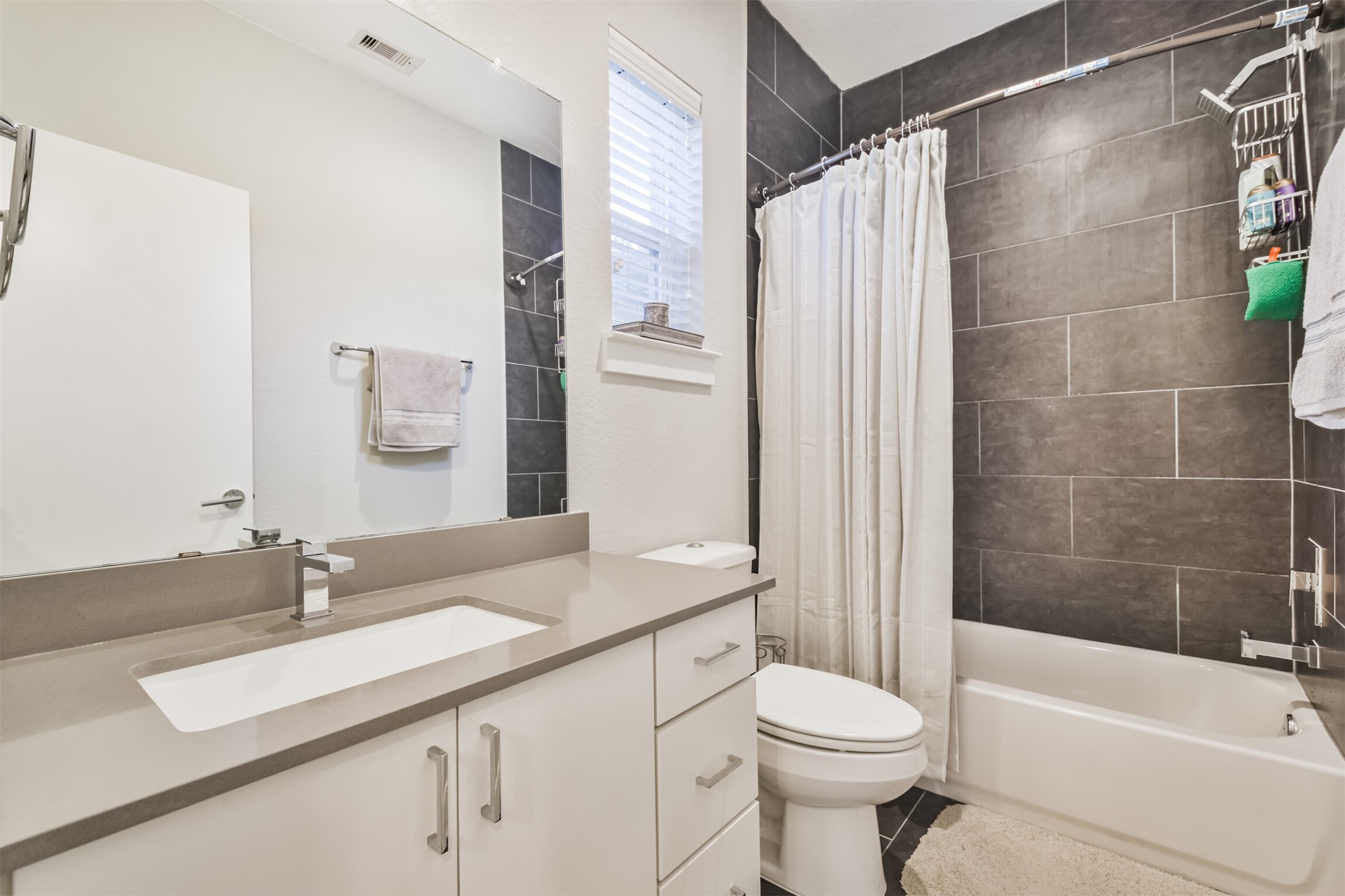 8411 Hempstead Road, Unit H Houston, TX 77008 - Photo 9 of 40 Modern fixtures, a sleek shower, and a clean, minimalist design.