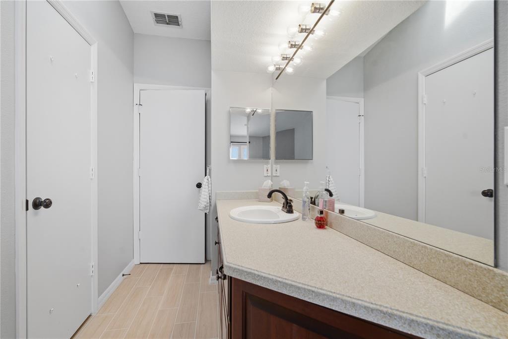643 Garland Circle Indian Rocks Beach, FL 33785 - Photo 39 of 81 a bathroom with a sink and a mirror