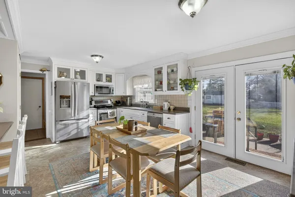 a kitchen with a sink appliances and cabinets