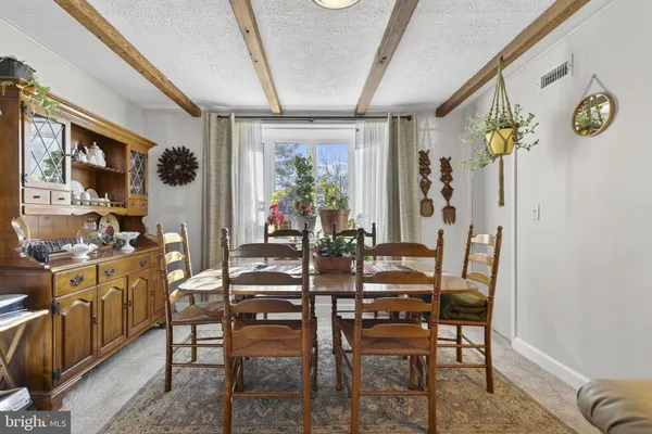 a view of a dining room with furniture and window