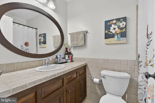 a bathroom with a toilet and a shower curtain