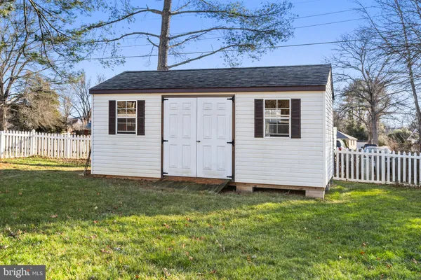 a front view of a house with a yard table and chairs