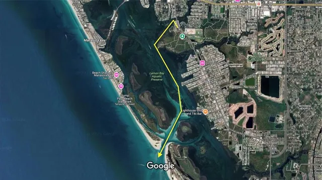 a view of a patio with a table chairs and a floor to ceiling window