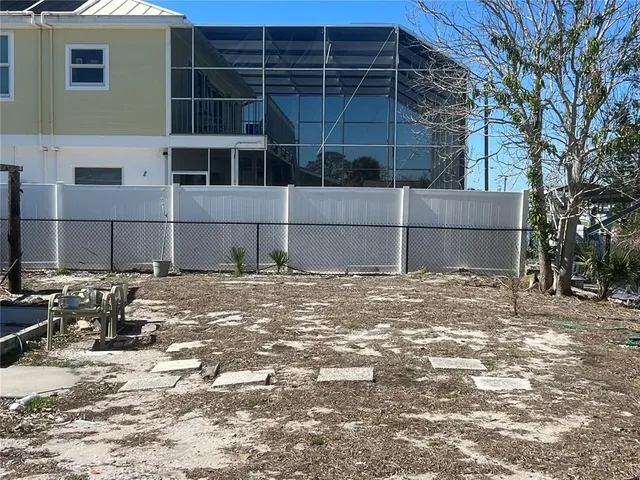 a view of a patio with table and chairs and potted plants