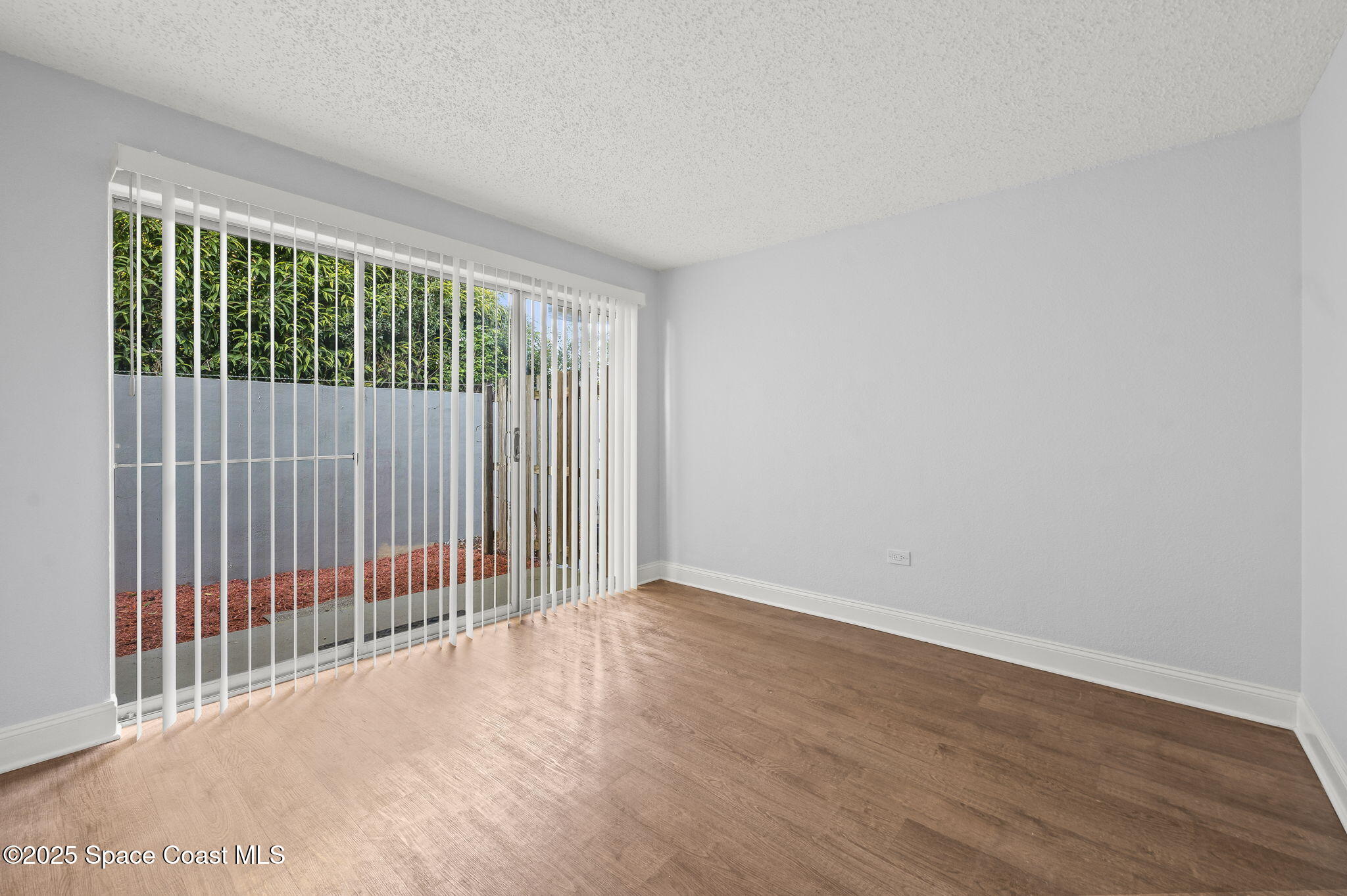 1170 South Patrick Drive, Unit 29 Satellite Beach, FL 32937 - Photo 15 of 18 a view of an empty room with wooden floor