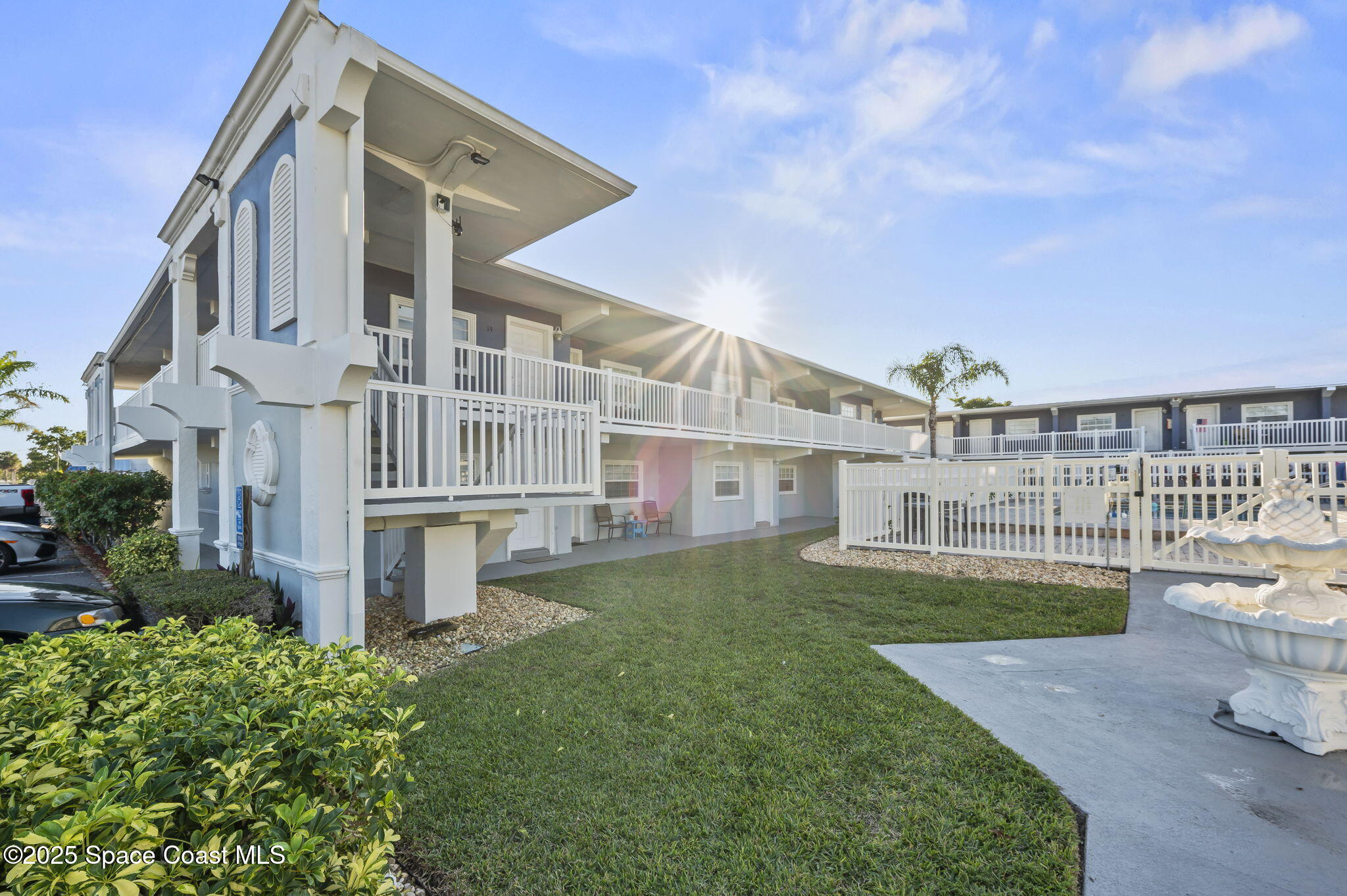 1170 South Patrick Drive, Unit 29 Satellite Beach, FL 32937 - Photo 6 of 18 a view of a house with a yard and plants