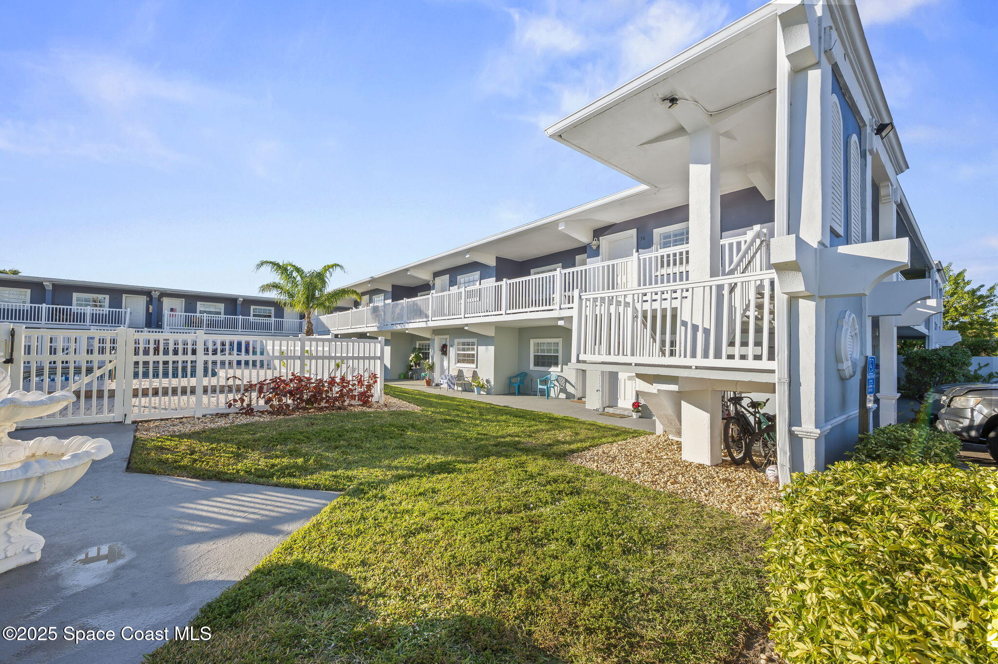 1170 South Patrick Drive, Unit 29 Satellite Beach, FL 32937 - Photo 7 of 18 a front view of a house with a garden