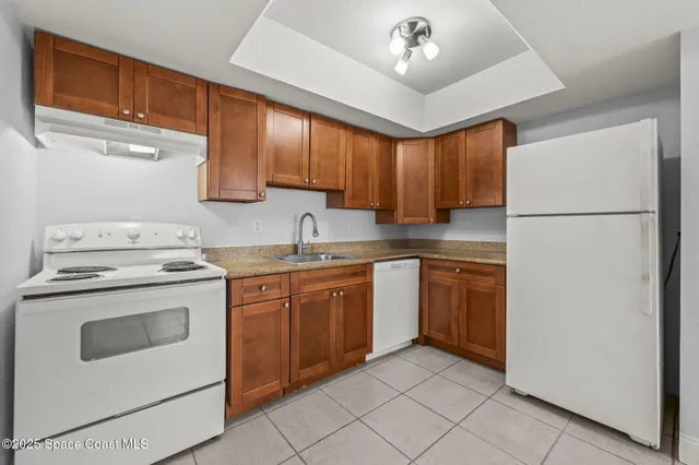 a kitchen with a stove sink and a refrigerator