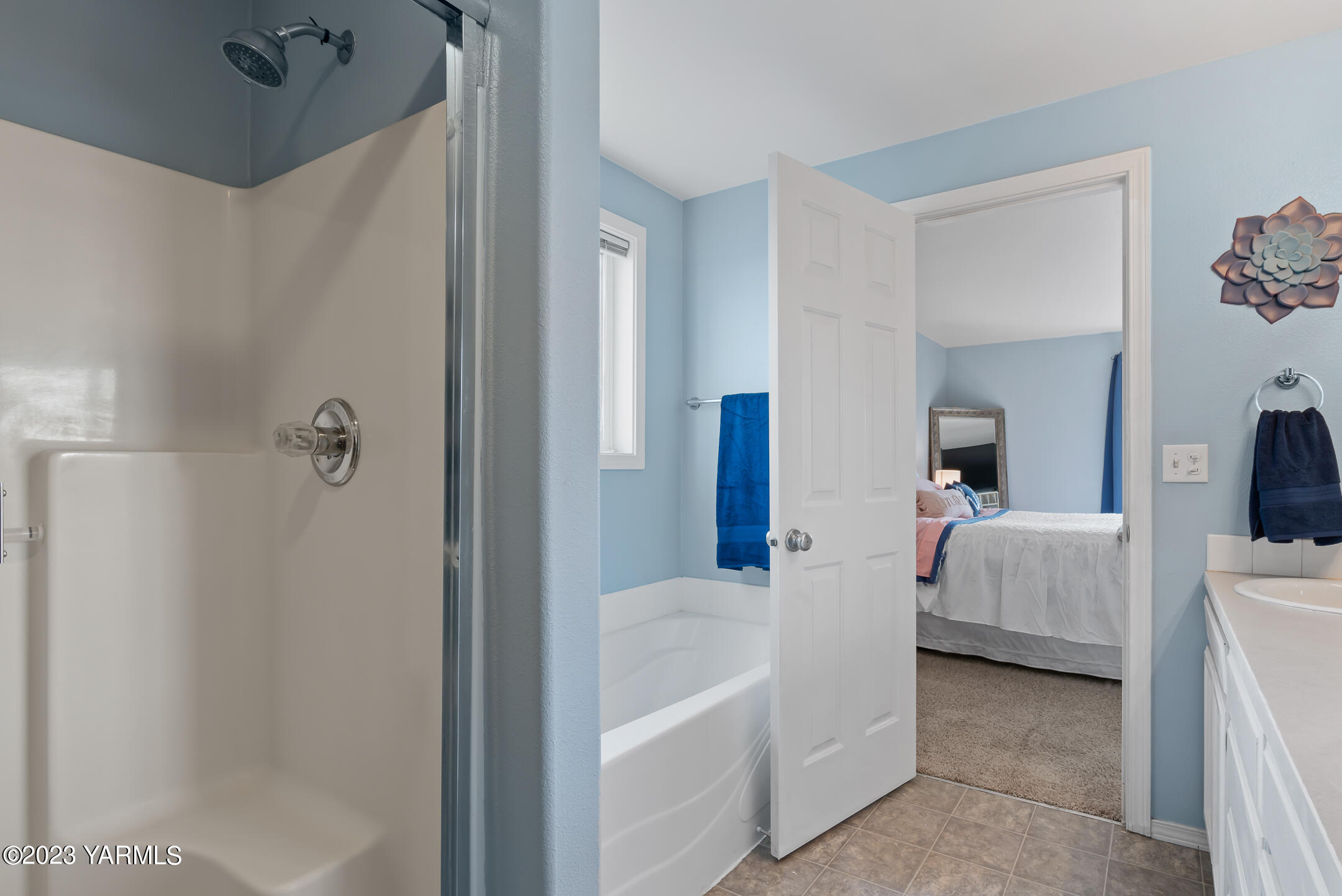 213 Perle Street Moxee, WA 98936 - Photo 19 of 27 a en suite bathroom with a tub shower and bedroom view