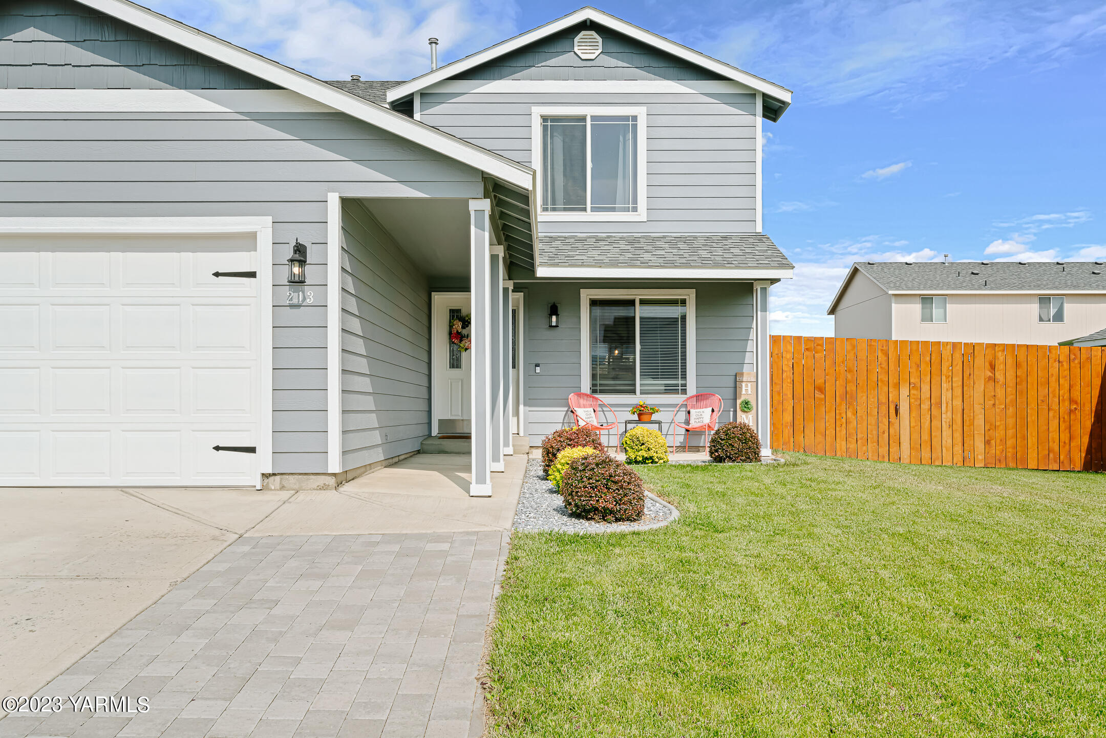 213 Perle Street Moxee, WA 98936 - Photo 2 of 27 a front view of a house with a yard and garage