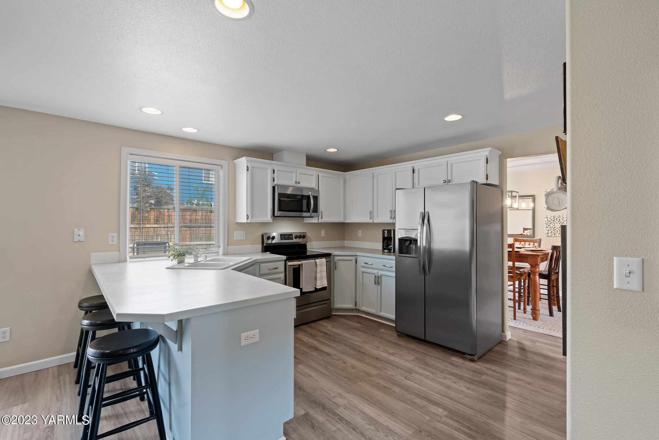 213 Perle Street Moxee, WA 98936 - Photo 9 of 27 a kitchen with refrigerator cabinets and wooden floor