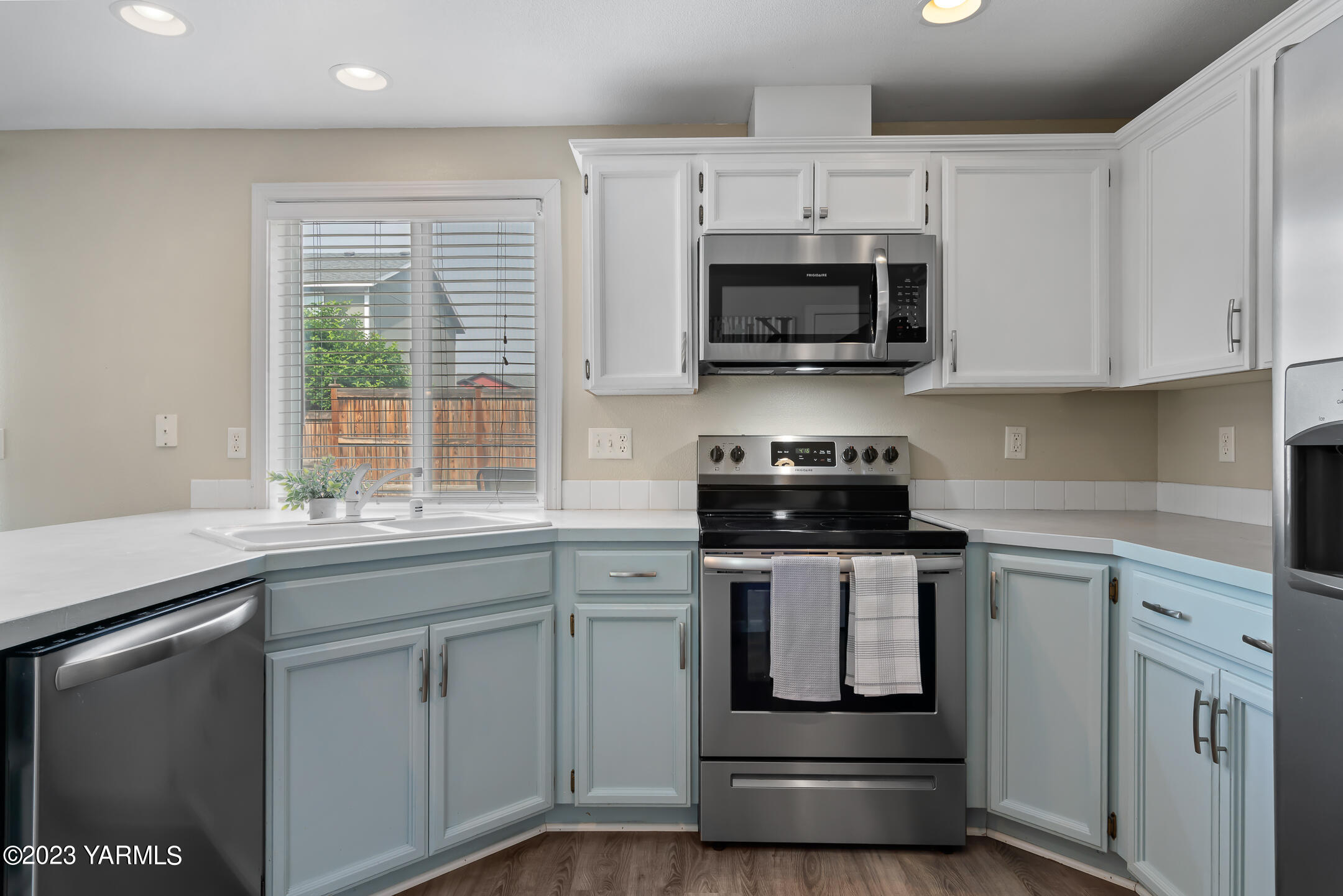 213 Perle Street Moxee, WA 98936 - Photo 10 of 27 a kitchen with stainless steel appliances a stove a sink and a microwave