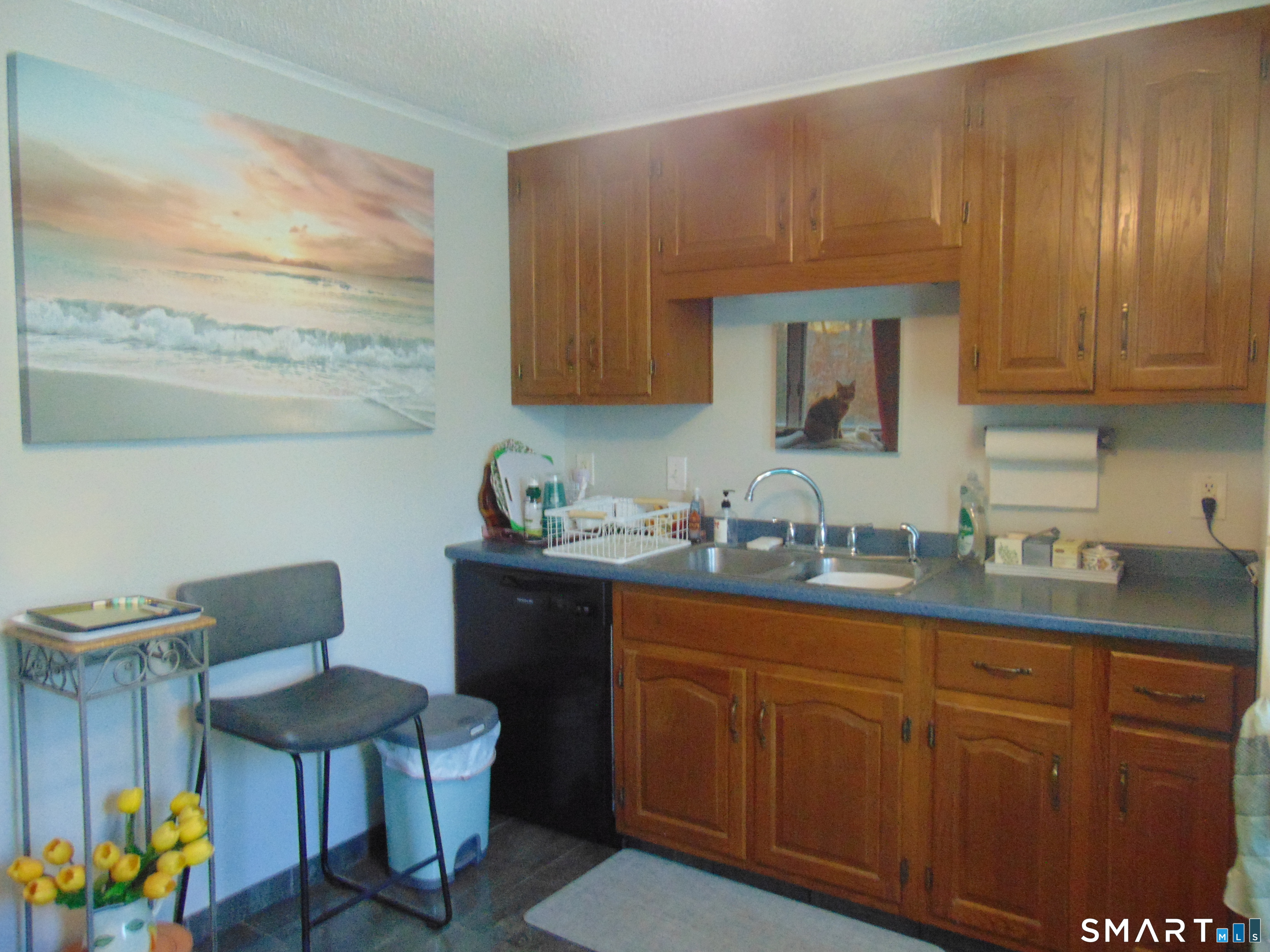 882 North Colony Road, Unit 31 Meriden, CT 06450 - Photo 18 of 34 a kitchen with sink cabinets and chair