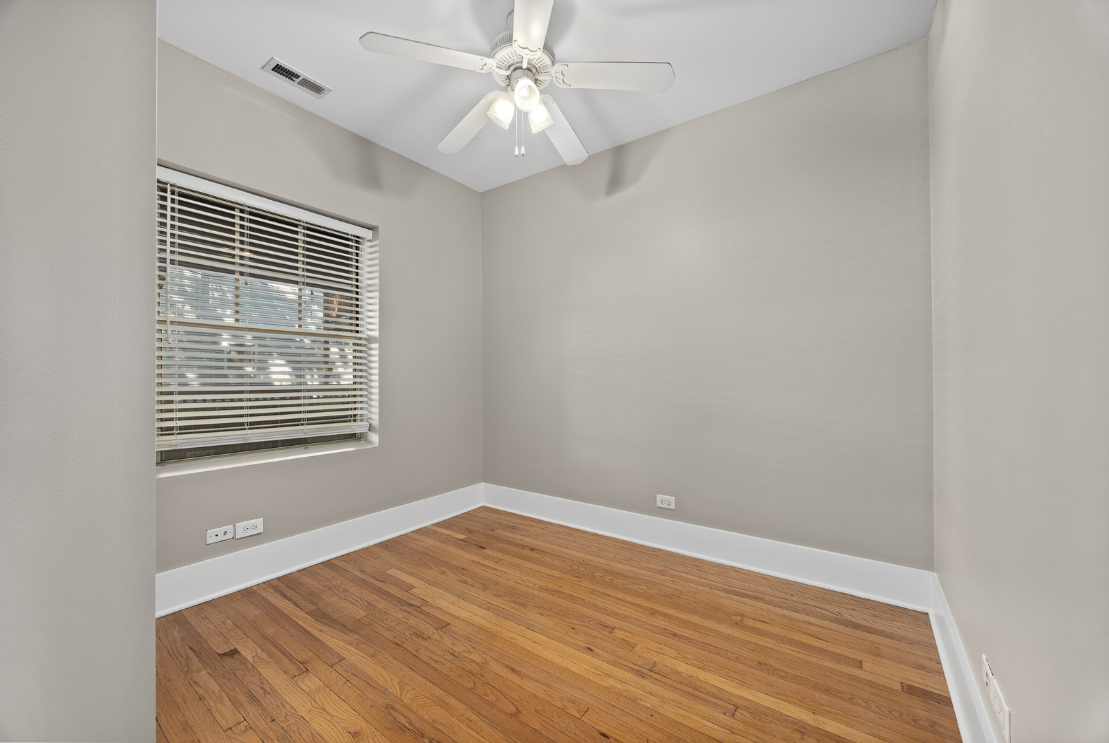 3418 North Wolcott Avenue, Unit 1N Chicago, IL 60657 - Photo 11 of 16 a view of an empty room with wooden floor and a window