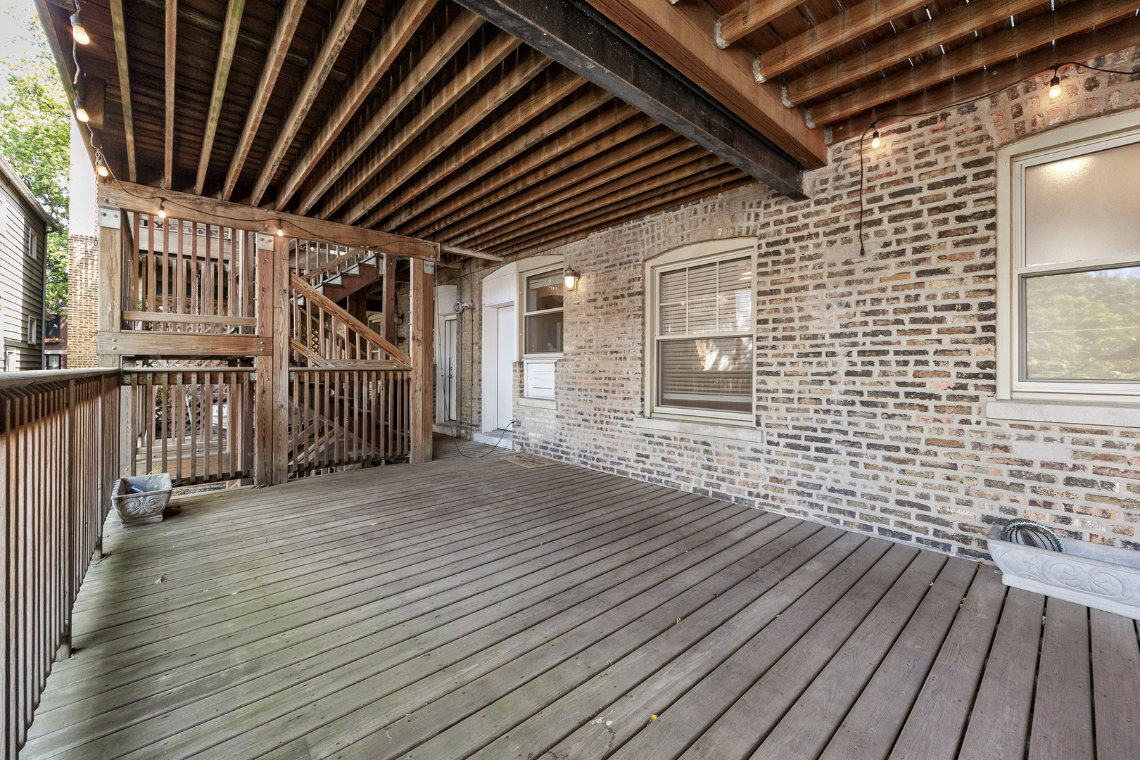 3418 North Wolcott Avenue, Unit 1N Chicago, IL 60657 - Photo 14 of 16 an empty room with wooden floor and windows