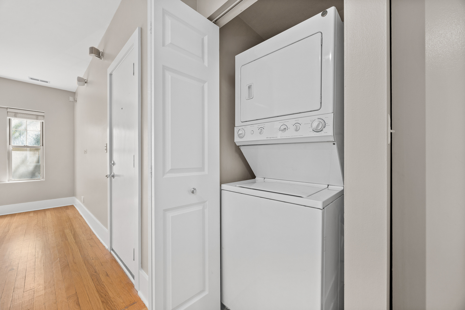 3418 North Wolcott Avenue, Unit 1N Chicago, IL 60657 - Photo 10 of 16 a view of washer and dryer with bathroom in the background