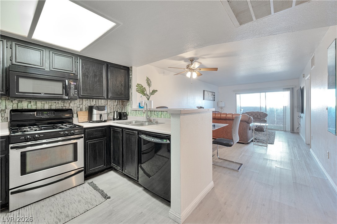 8025 West Russell Road, Unit 1090 Las Vegas, NV 89113 - Photo 22 of 23 An open floorplan seamlessly connects the functional kitchen space to the adjoining living area.