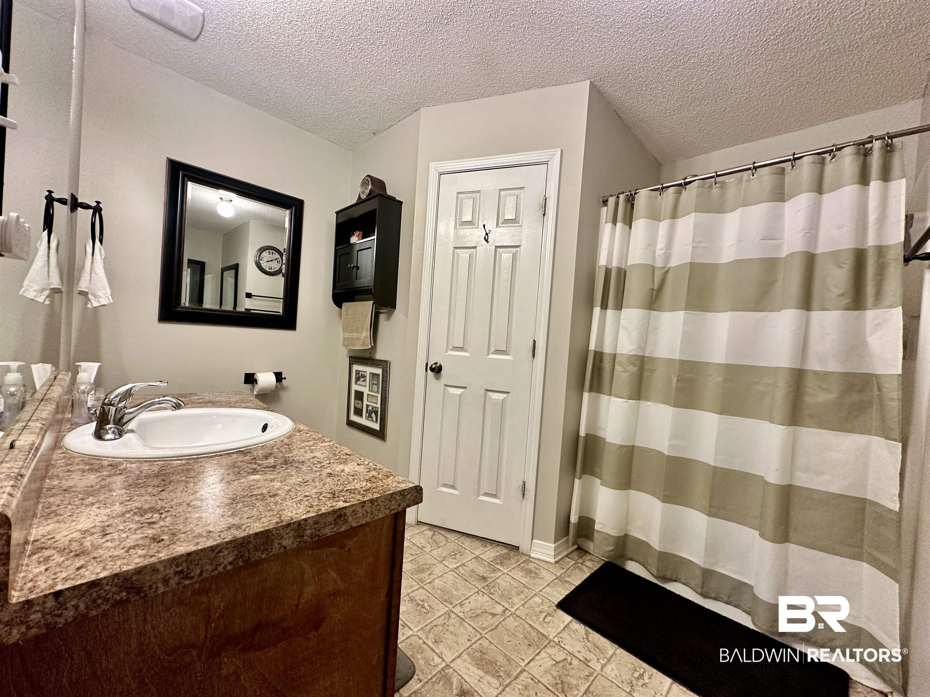 2456 Smith Road Castleberry, AL 36432 - Photo 11 of 26 Bathroom with vanity and a textured ceiling