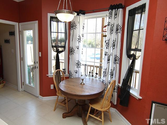 282 Saddle Ridge Drive Willow Spring, NC 27592 - Photo 11 of 23 a dining room with furniture and a floor to ceiling window
