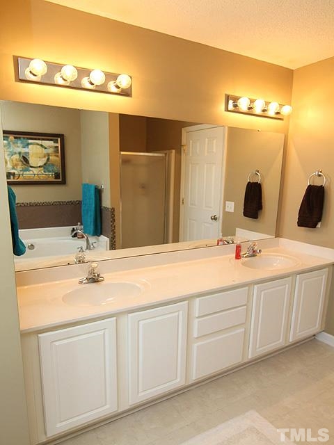 282 Saddle Ridge Drive Willow Spring, NC 27592 - Photo 14 of 23 a bathroom with a double vanity sink and mirror