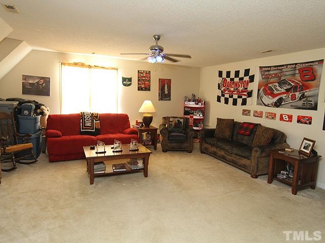 282 Saddle Ridge Drive Willow Spring, NC 27592 - Photo 16 of 23 a living room with furniture a couch and a flat screen tv