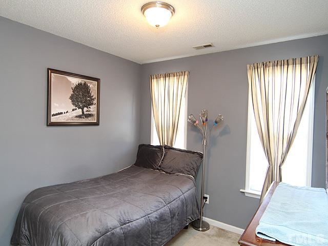 282 Saddle Ridge Drive Willow Spring, NC 27592 - Photo 18 of 23 a bedroom with bed and window
