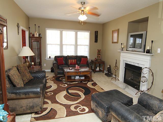 282 Saddle Ridge Drive Willow Spring, NC 27592 - Photo 5 of 23 a living room with furniture and a fireplace