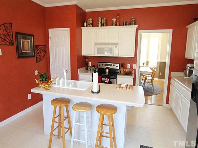 282 Saddle Ridge Drive Willow Spring, NC 27592 - Photo 10 of 23 a kitchen with a table and chairs